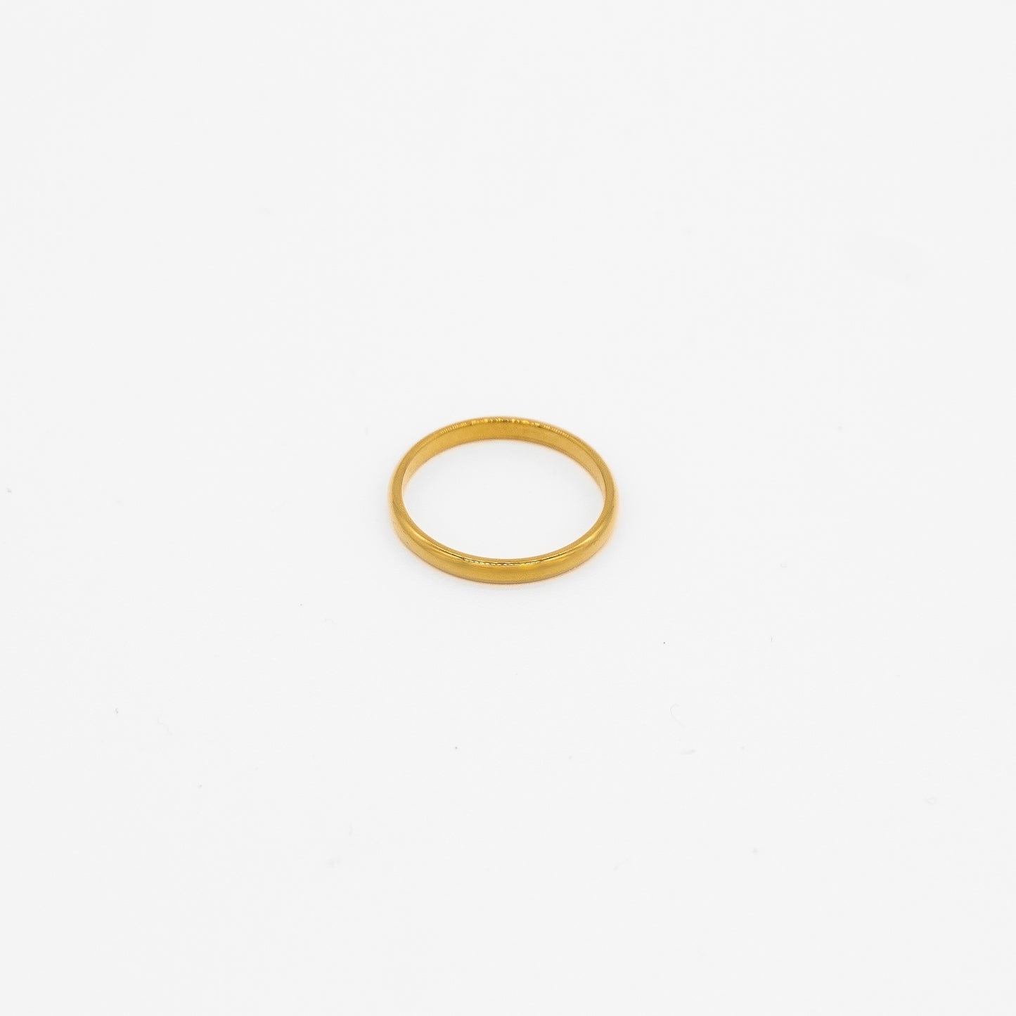 Gold simple ring on a white background