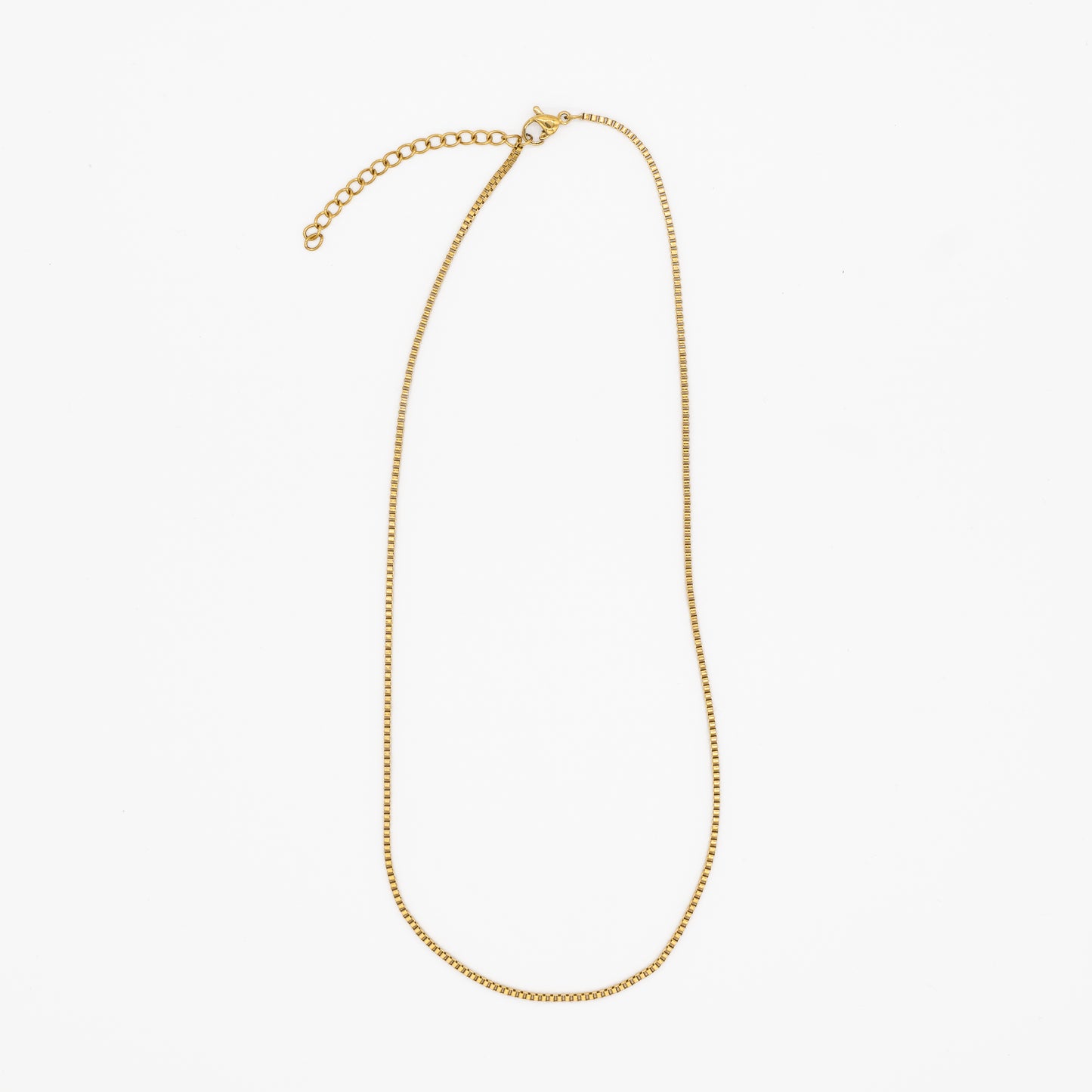 Gold "box" necklace on a white background