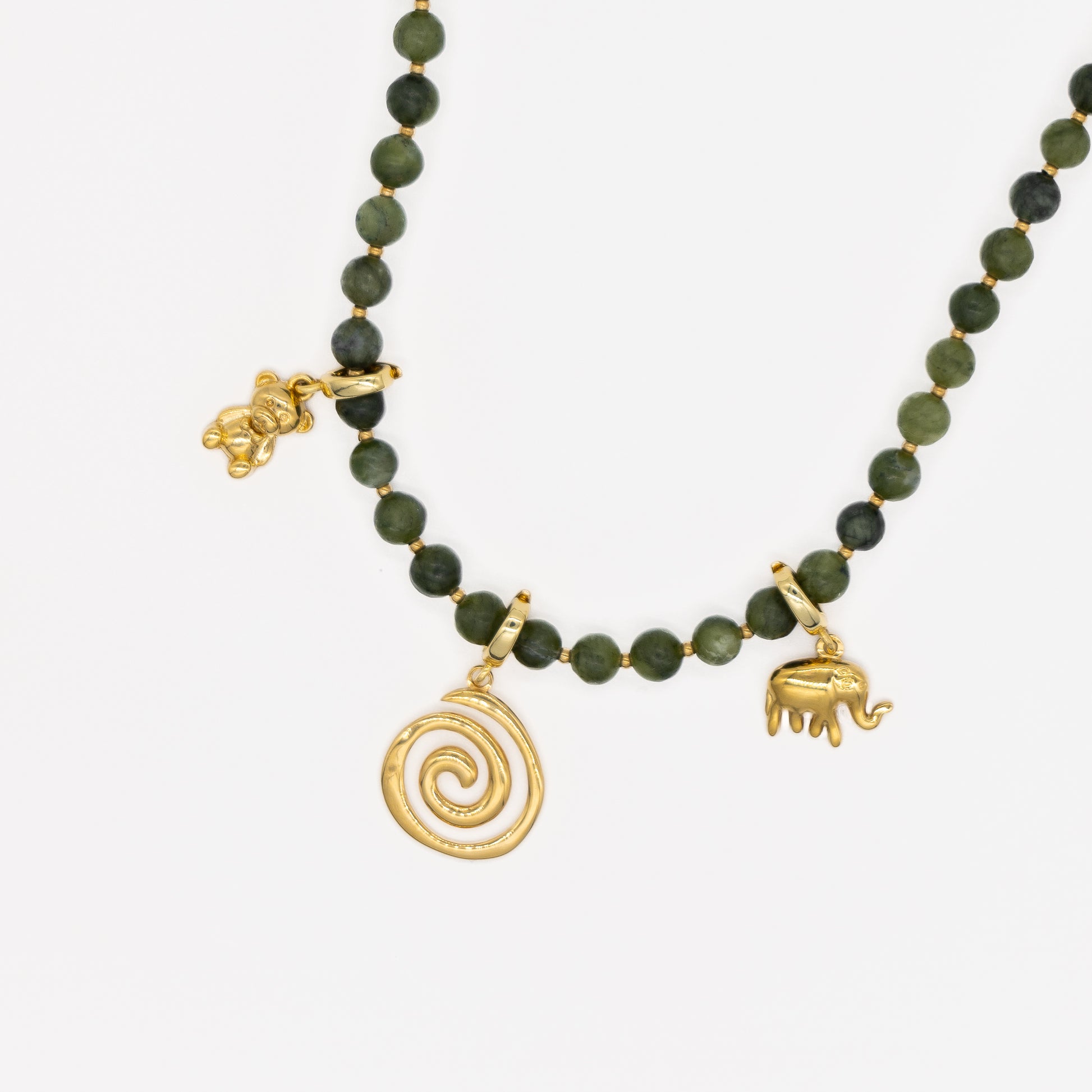 Necklace with green beads and gold charms on a white background