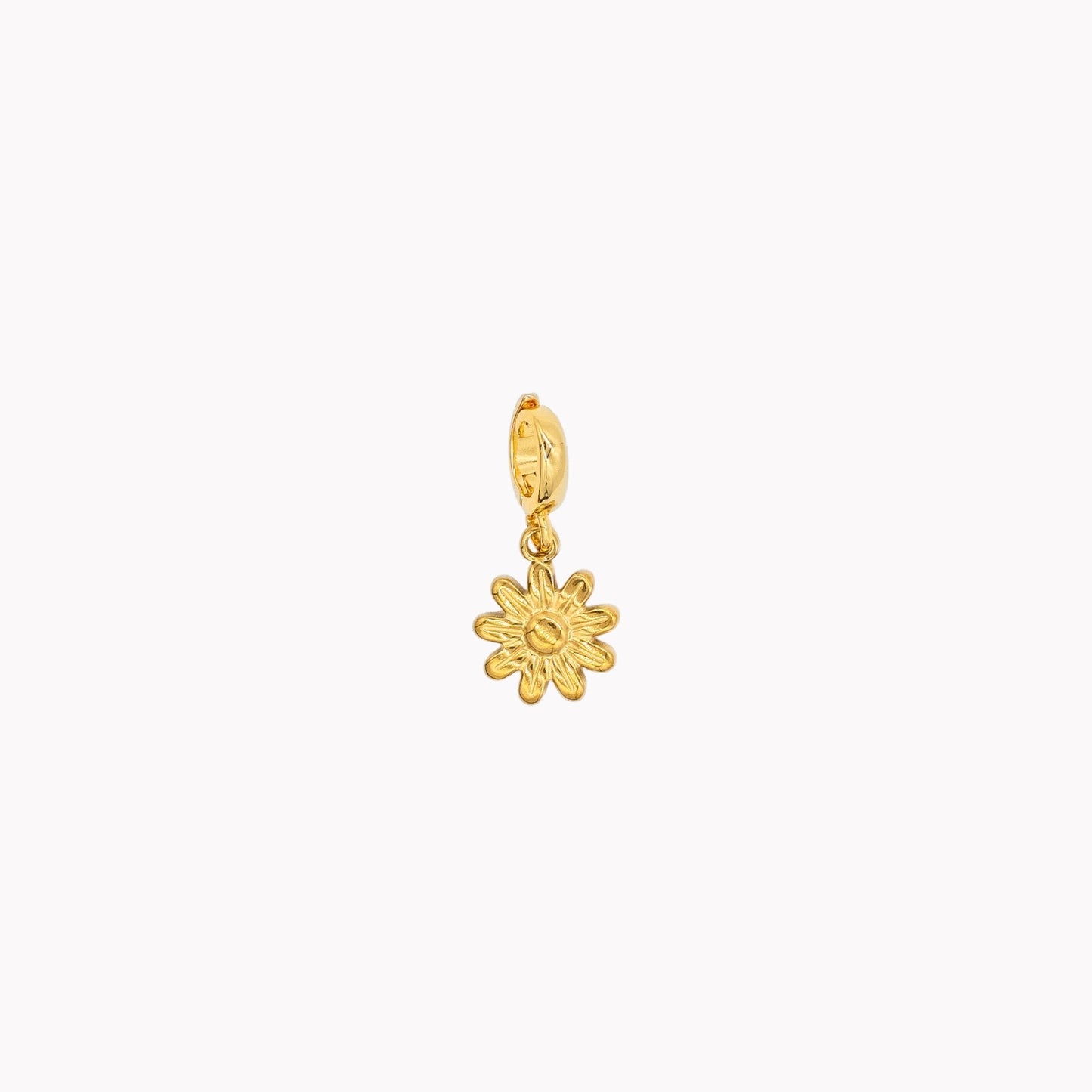 Gold flower-shaped pendant on a white background. Clip-on charm that can be opened and closed.