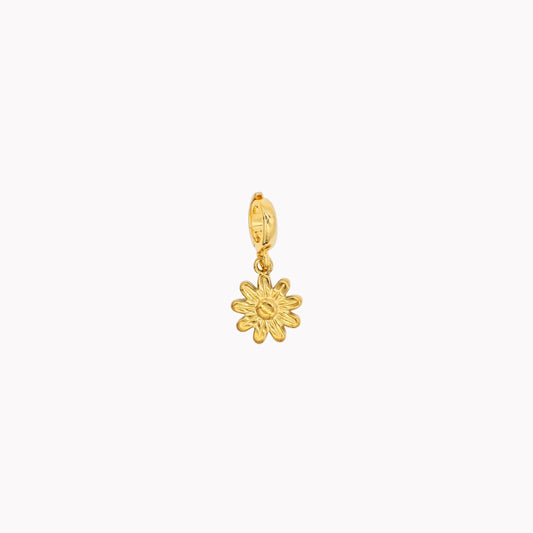 Gold flower-shaped pendant on a white background. Clip-on charm that can be opened and closed.