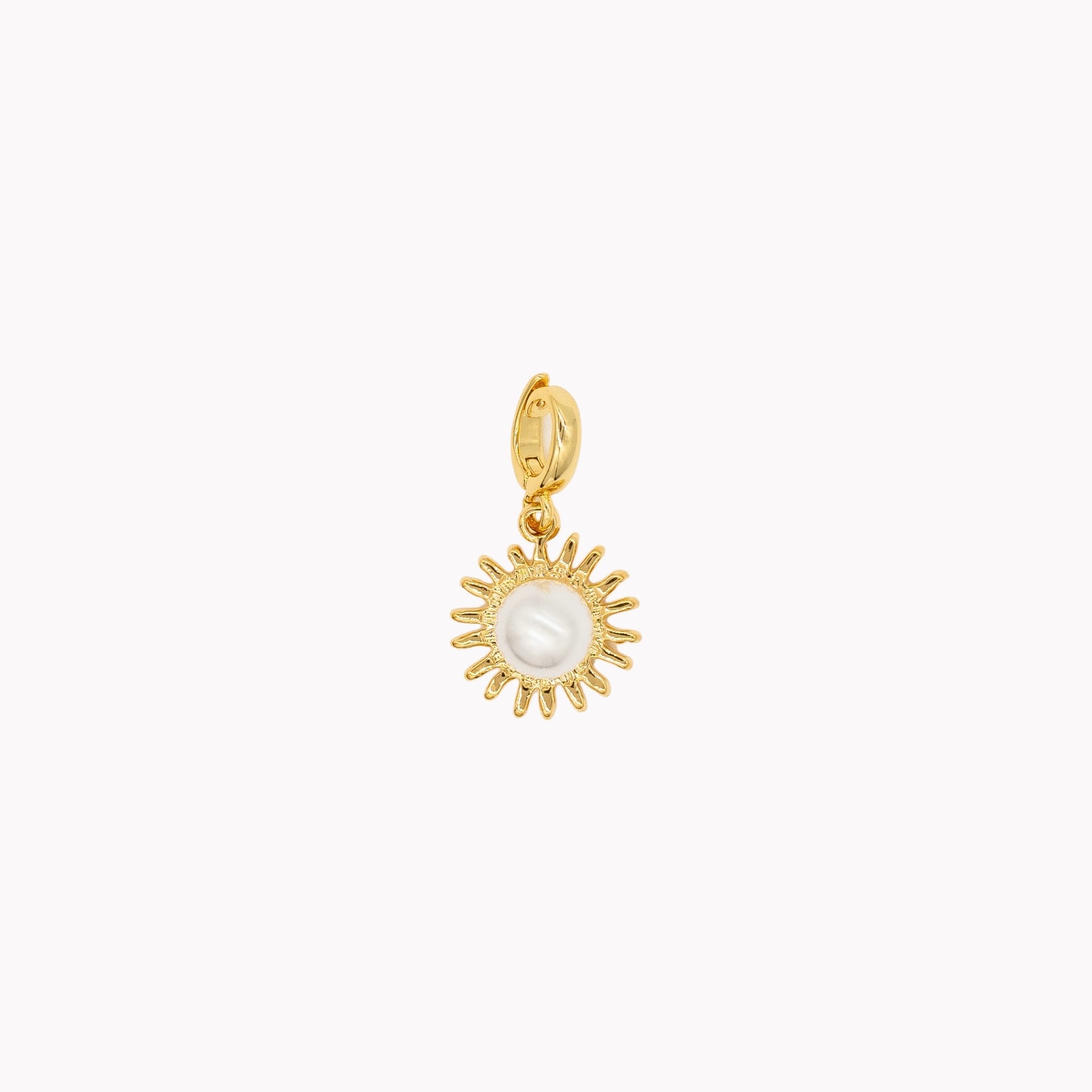 Gold sun-shaped pendant with a pearl center on a white background. Clip-on charm that can be opened and closed.