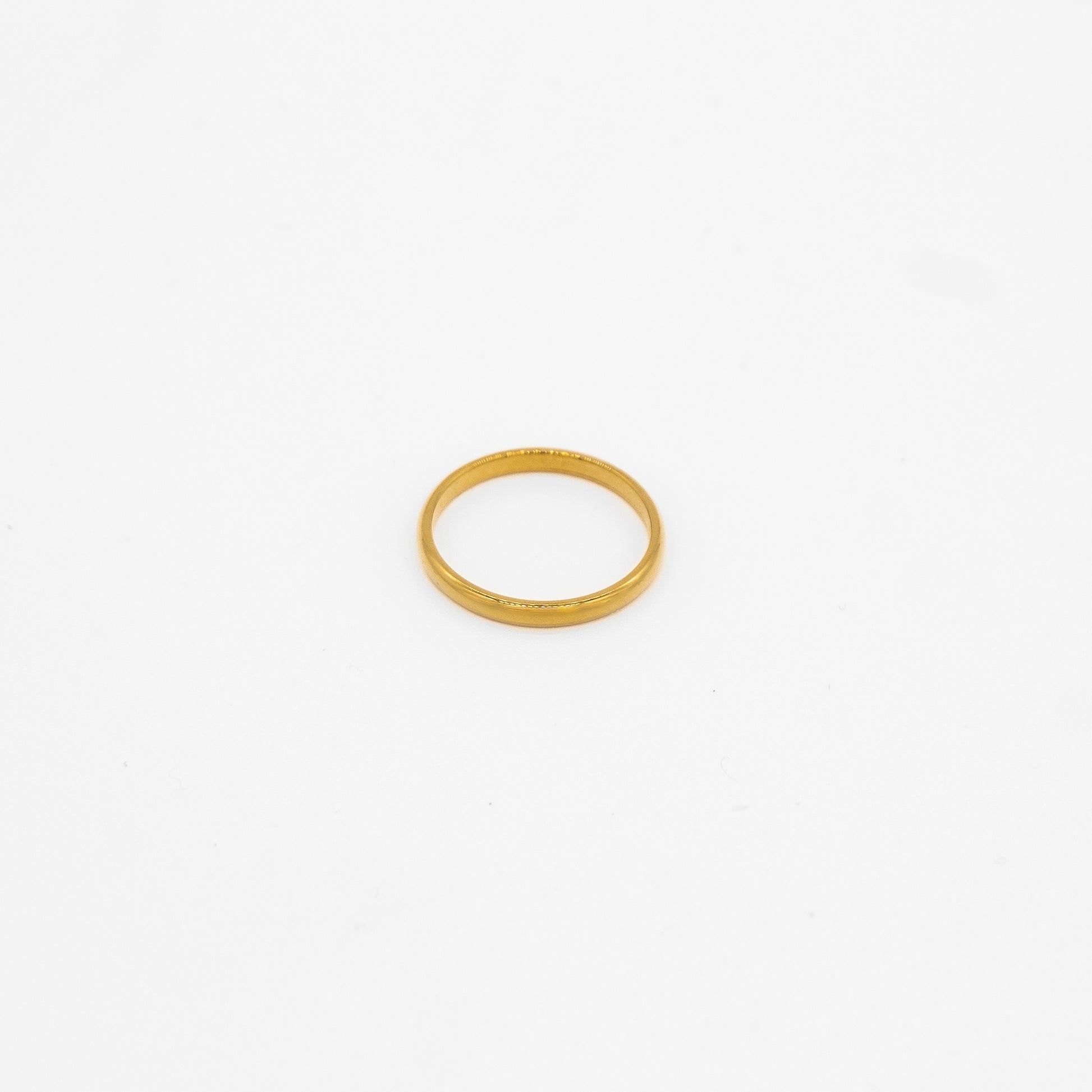Gold simple ring on a white background