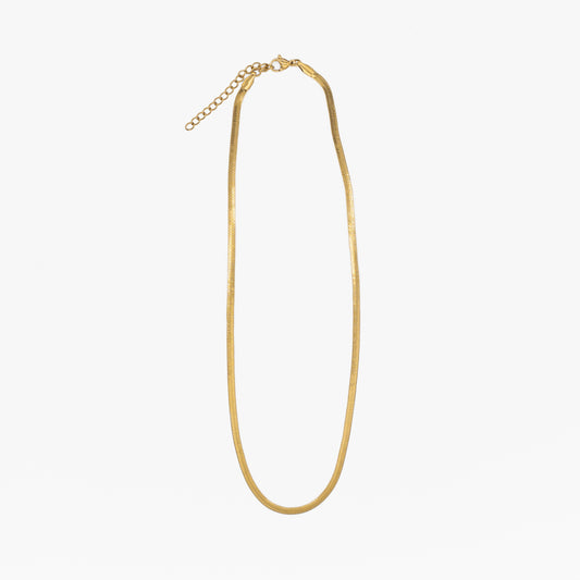 Gold "snake" necklace on a white background
